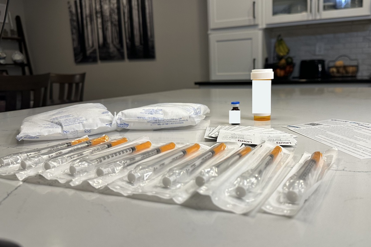 Eden Health medication vial alongside two large ice packs that kept it cool, extra sharps and alcohol wipes