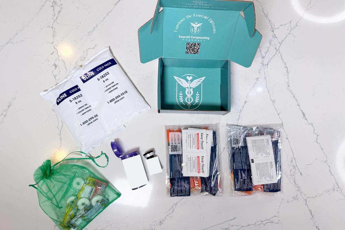 Peak Wellness package box, next to the two large ice packs, two packs of extra sharps and alcohol wipes, medication vial, and a bag of extra supplies
